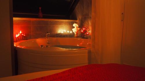 a bathroom with a sink with lights on it at Microyal Hotel in Antalya