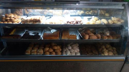 a display case filled with lots of different types of donuts at minha casa por dia in Goiânia