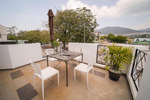a balcony with a table and chairs on a balcony at The Best Hotel in Bayan Lepas - THE LOV PENANG in Bayan Lepas