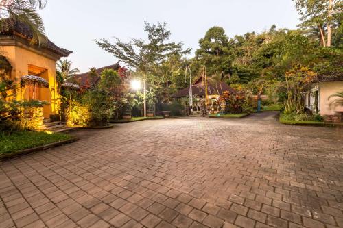 a cobblestone driveway in front of a house at Villa Taman di Blayu by Nagisa Bali in Tabanan