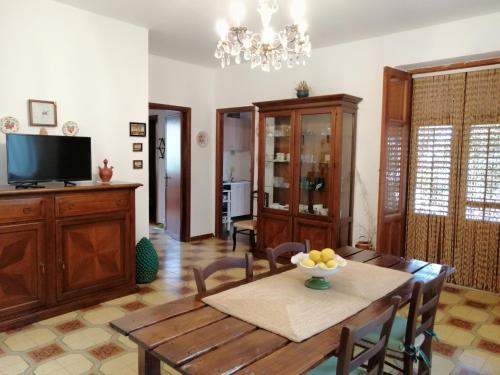 a dining room with a table and a television at Sale, amore e vento.... in Ficarazzi