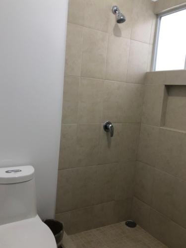 a bathroom with a shower with a toilet at CASA EN PRIVADA FRENTE A LA PLAYA CON ALBERCA! in Mazatlán