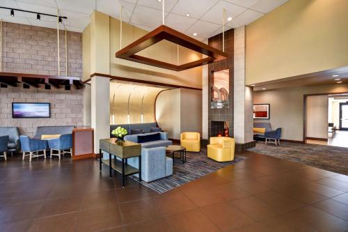 a lobby of a hotel with chairs and tables at Hyatt Place Phoenix Gilbert in Gilbert
