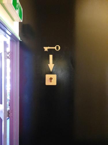 a door with a lock and a key on a wall at Archies Bunker Affordable Accommodation in Napier