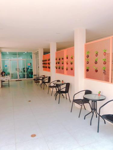 a dining room with tables and chairs and wine racks at Chiangmun Boutique in Chiang Mai