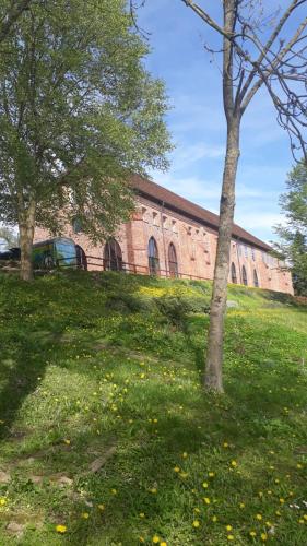 a large brick building with trees in the grass at Landhaus am Schaalsee in Zarrentin