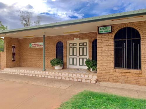 a brick building with a street sign in front of it at Gilgandra Motel in Gilgandra
