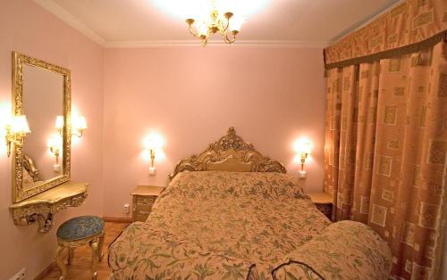 a bedroom with a bed and a mirror at Mango Hotel in Tampere