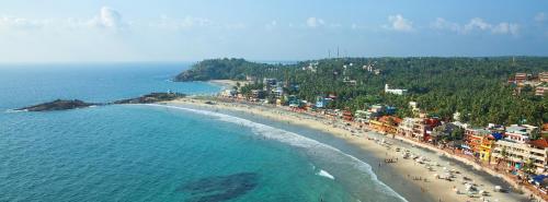 an aerial view of a beach with people on it at Marine Palace Beach Hotel in Kovalam