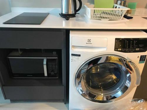 a washing machine sitting next to a microwave at CBD Asoke/Nana/Ploenchit +2 mins to Terminal 21 in Bangkok
