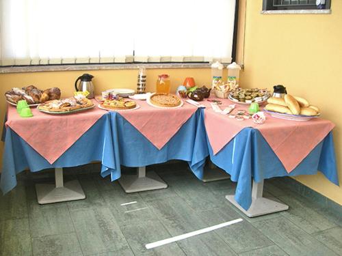 a table with plates of food on it at Caffè Nuovo 2 Holiday Rooms in Trappitello