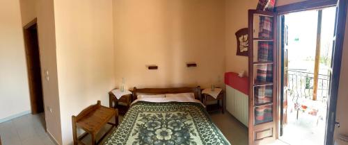 a small bedroom with a bed and a balcony at Sofia Rooms in Kissos