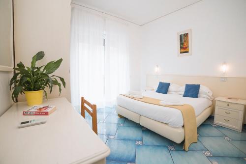 Postel nebo postele na pokoji v ubytování Hotel De Rosa