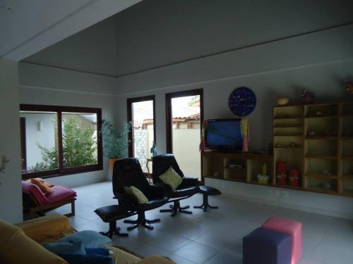 a living room with a couch and a chair at Suites Solanas De Porto in Porto De Galinhas