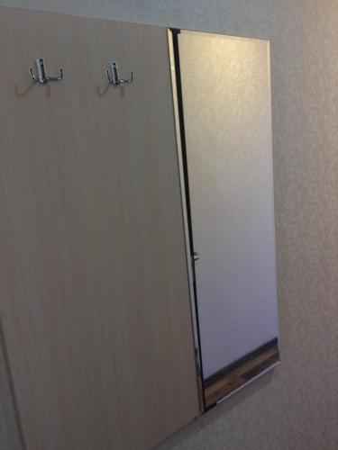 a bathroom stall with a mirror and a door at Hotel Paulina in Făleşti