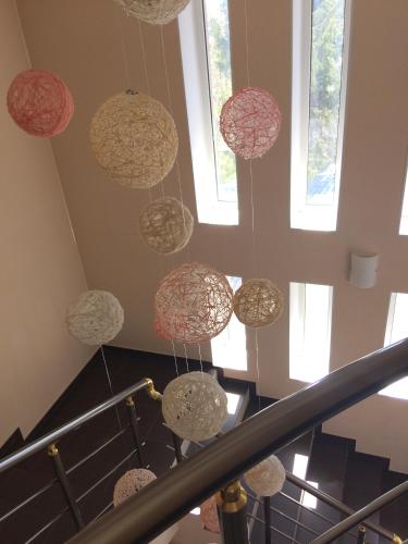 a group of pendant lights hanging from a stairway at Hotel Paulina in Făleşti