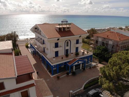 an overhead view of a house with the ocean in the background at Sea Garden Hotel in Acquappesa