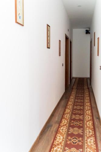 an empty hallway with a rug on the floor at Villa Juri Garden in Berat