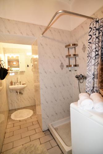 a bathroom with a shower and a sink at BETTY'S HOUSE in Pythagoreio