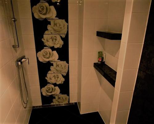 a bathroom with a bunch of towels on a wall at Apartmány u Arény Ostrava in Ostrava