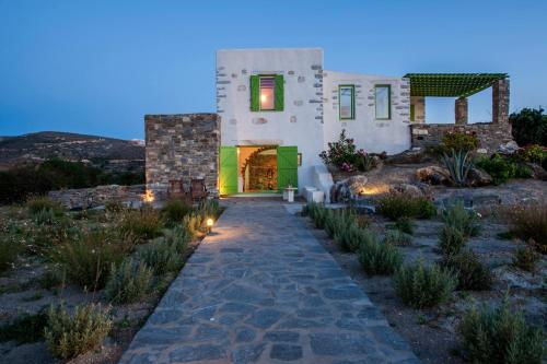 a house with a pathway leading to the front yard at Villa Aeolos with 2 private pools in Sarakíniko