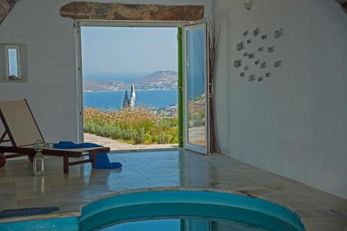 a room with a pool and a view of the ocean at Villa Aeolos with 2 private pools in Sarakíniko