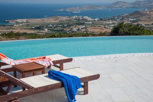 a blue towel sitting on a bench next to a pool at Villa Aeolos with 2 private pools in Sarakíniko