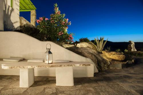 a white bench with a glass bottle on it at Villa Aeolos with 2 private pools in Sarakíniko