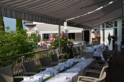 a row of tables and chairs on a patio at Castell Hotel & Restaurant in Leinsweiler