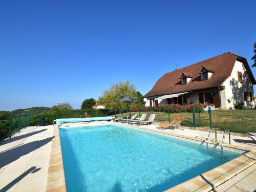 a swimming pool in front of a house at Comfy villa near Alvignac with private pool in Alvignac