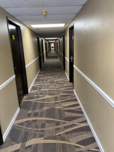 a hallway of an office building with a carpeted floor at Super 8 by Wyndham Eau Claire WI in Eau Claire