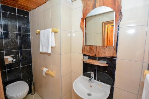 a bathroom with a sink and a mirror at Otel Wood House in Antalya