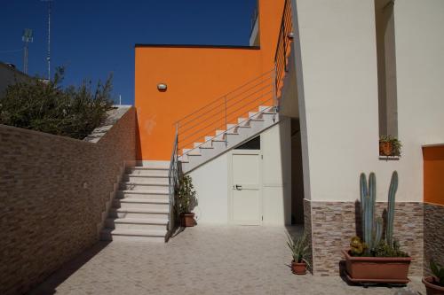 a stairway leading up to a garage with cactus at Appartamento a due passi dal mare in Torre Lapillo