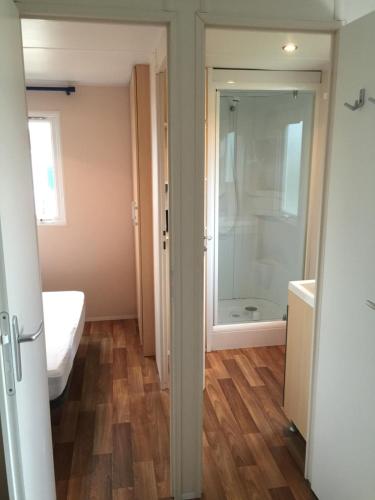 a bathroom with a shower and a sink and a toilet at Camping les Palmiers in La Trinité-sur-Mer