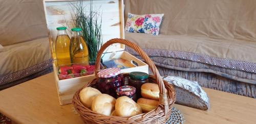 a basket of bread on a table next to a couch at Beautiful house surrounded by pure nature in Rogašovci