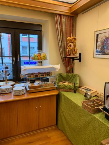 a waiting room with a table with food on it at Zum Winzermännle in Würzburg
