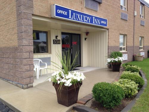 a front entrance to a building with flowers on the sidewalk at Luxury Inn in Collingwood