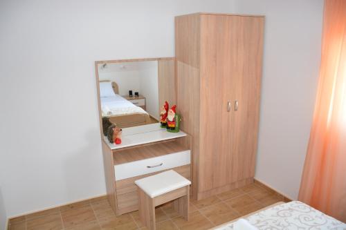 a small bedroom with a mirror and a bed at Apartmani Gaga in Tivat