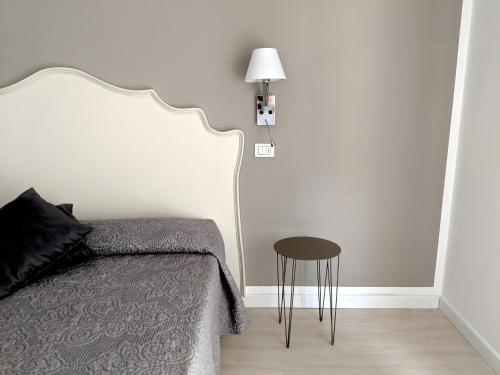 a bedroom with a bed and a side table at Hotel Piccolo Mondo in Lido di Camaiore