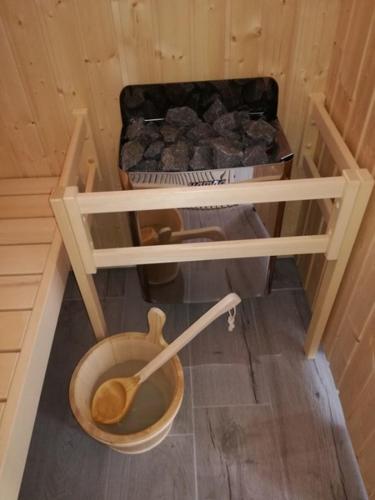 a bathroom with a wooden toilet in a room at Chante Grelet in Châtel-Guyon
