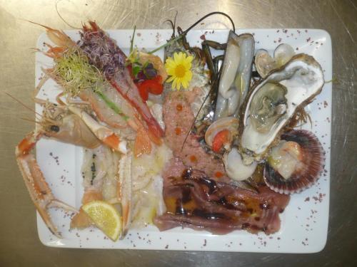 a plate of food with seafood on a table at La Vela in Viadana