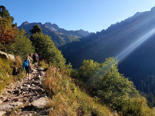 a group of people walking on a mountain trail at Apartman Breza in Vysoké Tatry