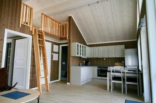 a kitchen with a loft conversion with a ladder at Bøflaten Camping AS in Vang I Valdres