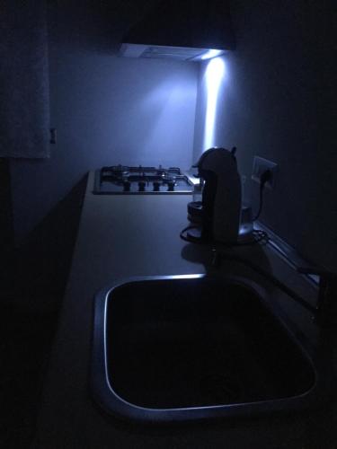 a kitchen with a sink and a light in the dark at Mini appartamenti a Catanzaro Lido in Catanzaro Lido