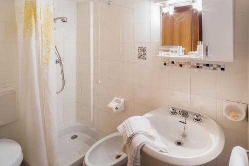 a bathroom with a sink and a shower and a toilet at Hotel Gilda in Laigueglia
