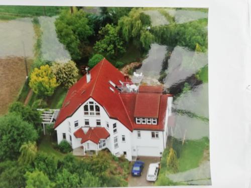 an aerial view of a house with a red roof at Modernes Schloss in Rommerskirchen