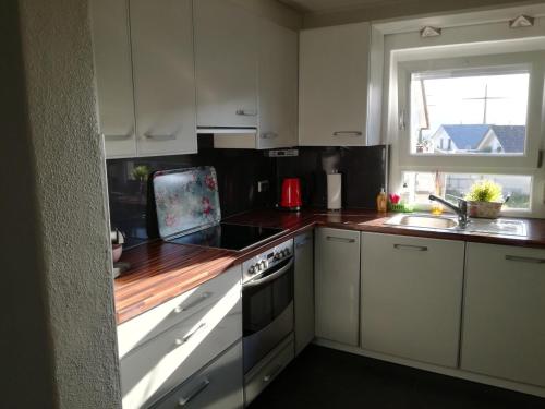 a kitchen with white cabinets and a stove top oven at Bella Casa in Laufenburg