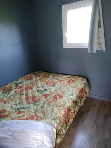 a bed sitting in a room with a window at eurl de l'écluse in Inor
