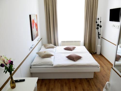 1 dormitorio con cama blanca y mesa en KIBI Rooms self check-in en Viena