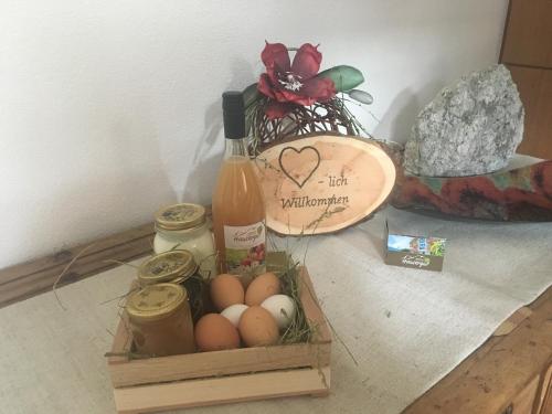 a crate of eggs and a bottle of wine at Bauernhof Residence Hausergut with Ortler views, central and quiet position in Sluderno